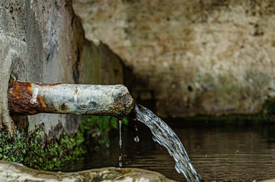 Close-up of water fountain against wall