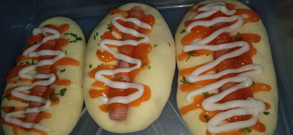 High angle view of hot dog and vegetables on plate