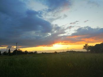 Scenic view of field against sky during sunset