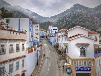 Street amidst buildings against sky in city