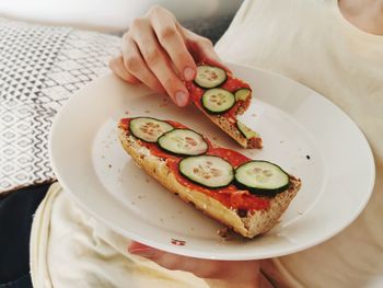 Midsection of woman holding ice cream in plate