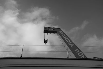 Low angle view of text on bridge against sky