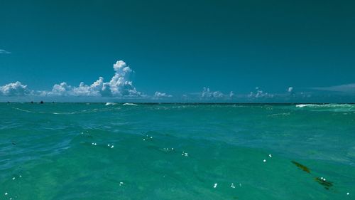 Scenic view of sea against blue sky