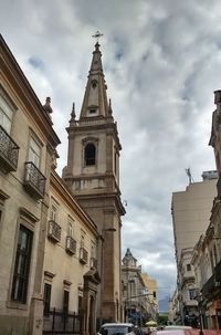 Low angle view of church against cloudy sky