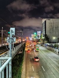 Cars on city street at night