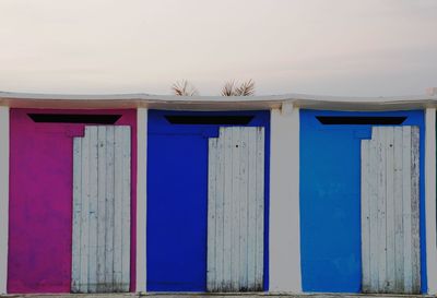 Blue wooden door of building against sky