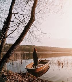 People sitting on boat in lake