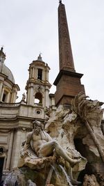 Low angle view of statue against sky