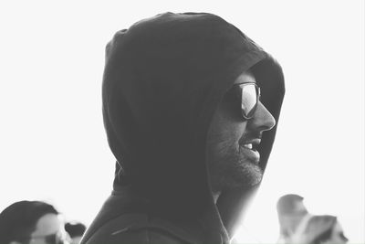 Close-up portrait of young man with sunglasses against sky