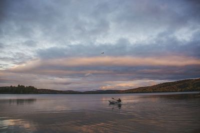 Scenic view of lake against dramatic sky