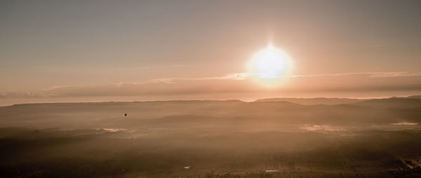 Scenic view of landscape against sky during sunset