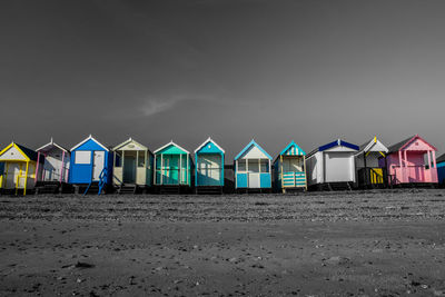 Row of beach huts against sky