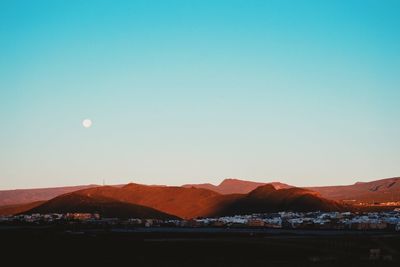 Scenic view of mountains against clear blue sky