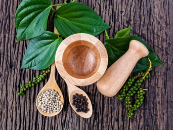 Close-up of spice with mortar and pestle on wooden table