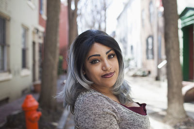 Portrait of beautiful young woman standing outdoors