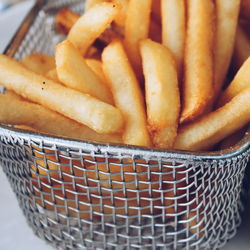 Close-up of french fries in metal container