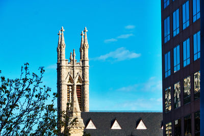 Low angle view of church building against clear blue sky