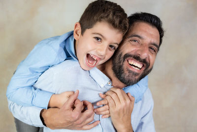 Father and son smiling isolated