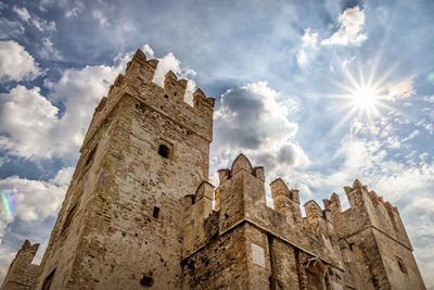 Low angle view of historic building against cloudy sky