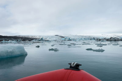 Scenic view of frozen sea seen from boat against sky