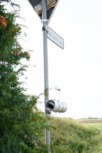 Close-up of telephone pole against sky