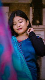 Young woman wearing traditional clothing at home