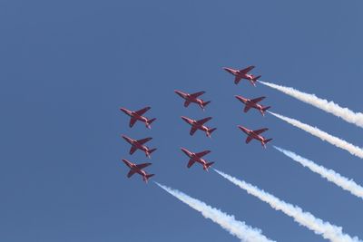 Low angle view of airshow against sky