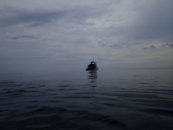 Sailboat sailing in sea against sky