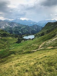 Scenic view of landscape and mountains against sky