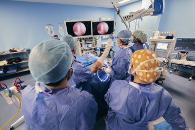 Doctor analyzing endoscope on computer monitor while standing at operating room