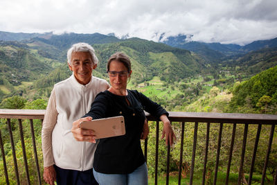 Senior mother and adult daughter traveling at the  view point over the cocora valley at salento