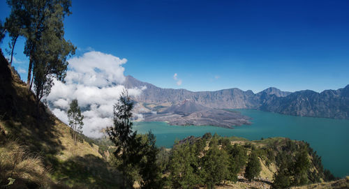 Scenic view of mountains against blue sky