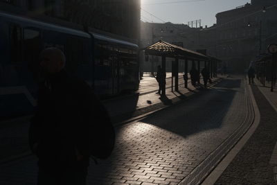Rear view of man walking on street at night