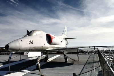 Airplane on road against sky