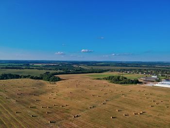 High angle view of field against blue sky