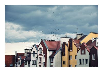 Buildings in town against sky