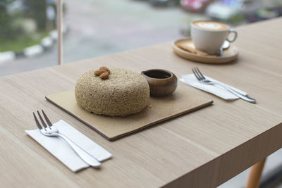 Close-up of sweet food with coffee on wooden table