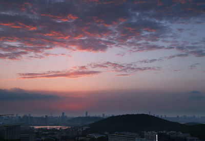 Cityscape against cloudy sky