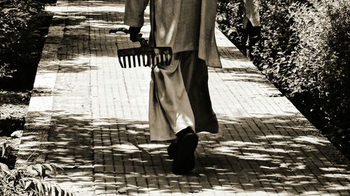 Low section of man standing on sidewalk