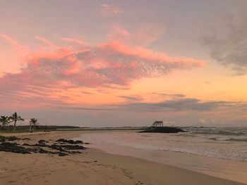 Scenic view of beach against sky during sunset