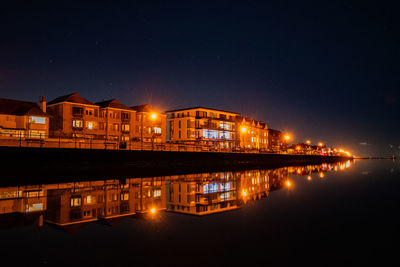 Illuminated buildings in city at night