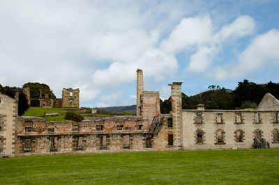 Ruins of building against cloudy sky