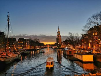 Canal passing through city buildings at dusk