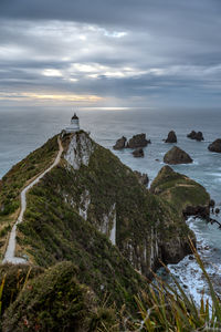 Nugget point lighthouse at sunrise, new zealand