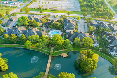 High angle view of plants by trees and buildings