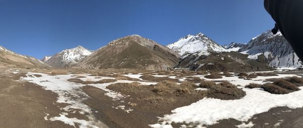 Scenic view of snowcapped mountains against clear sky