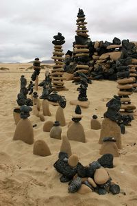 Rocks on beach against sky