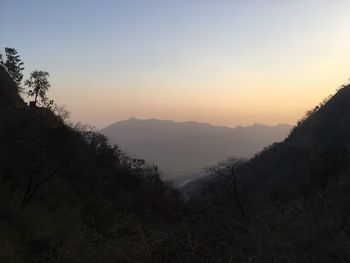 Scenic view of silhouette mountains against sky during sunset