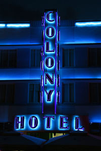 Low angle view of illuminated neon sign at night
