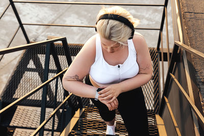 High angle view of woman standing on staircase